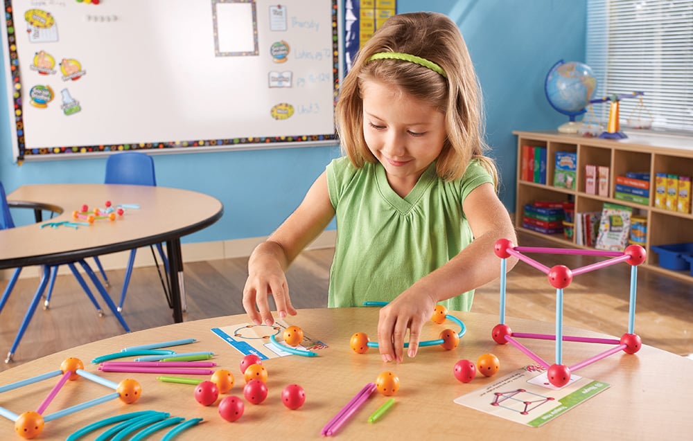 Girl arranging shapes from the building set