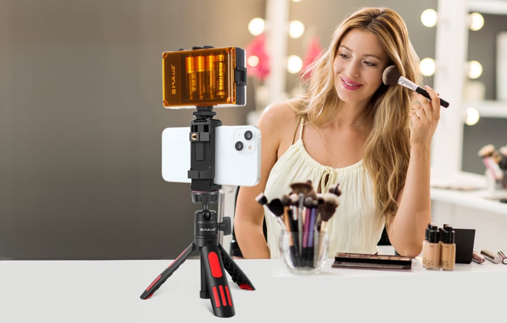 Woman doing makeup in front of smartphone mounted on Puluz tripod