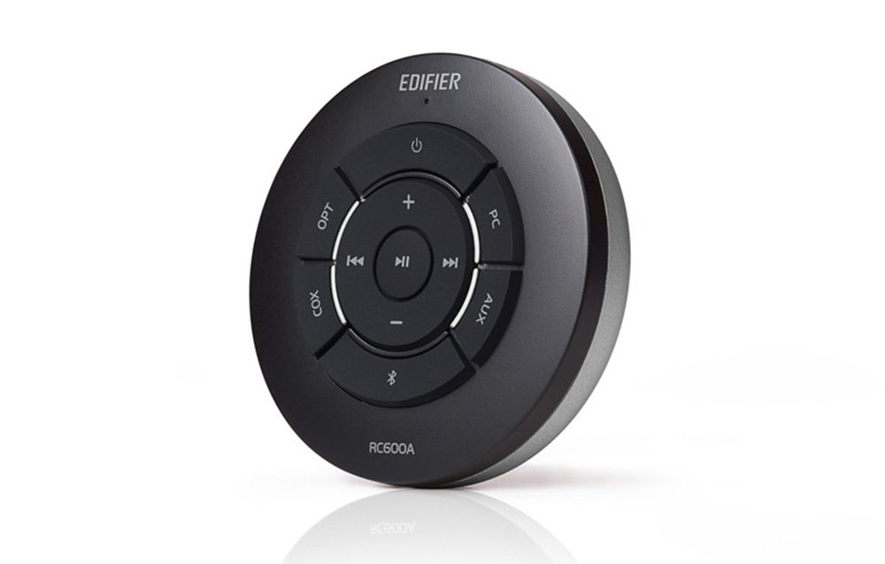 Black, round remote for Edifier speakers on a white background